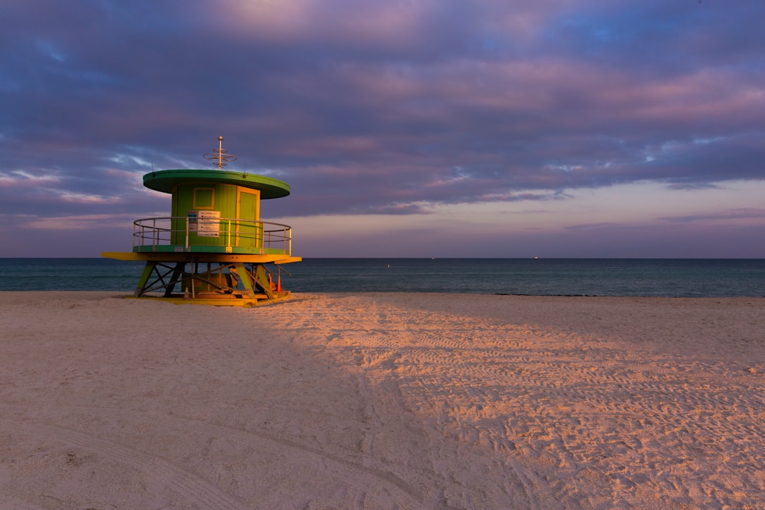 green and white lifeguard tower on beach during daytime