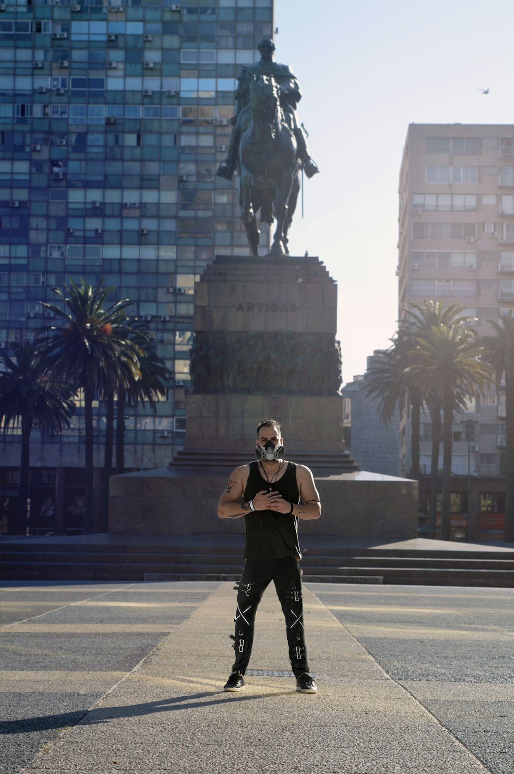 woman in black jacket and black pants standing near black horse statue during daytime