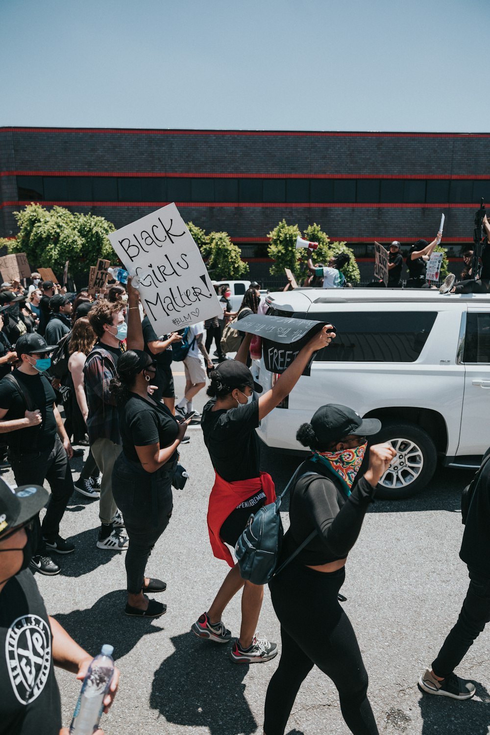 people in black and red shirts holding white printer paper