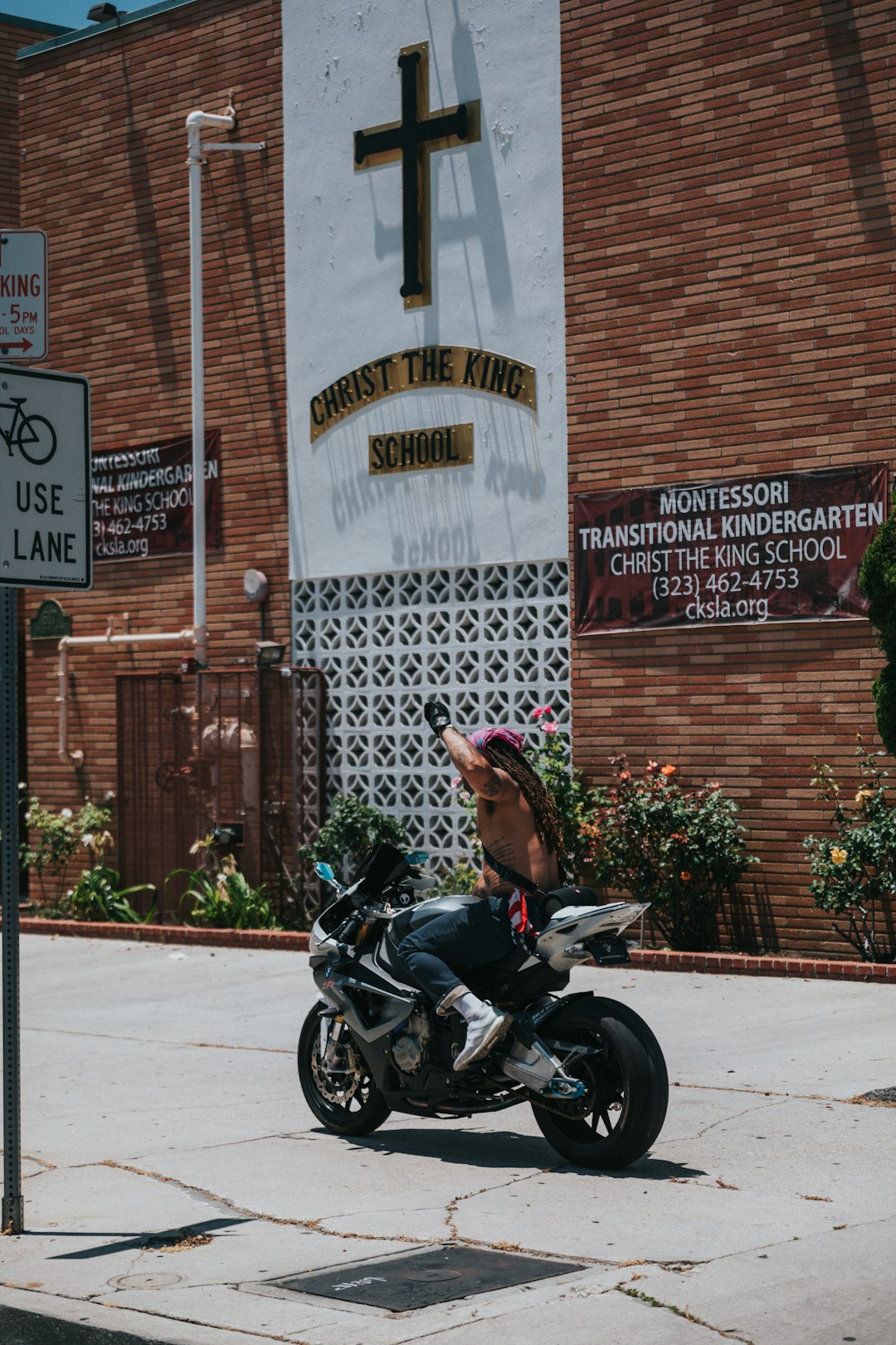 woman in black leather jacket riding black motorcycle