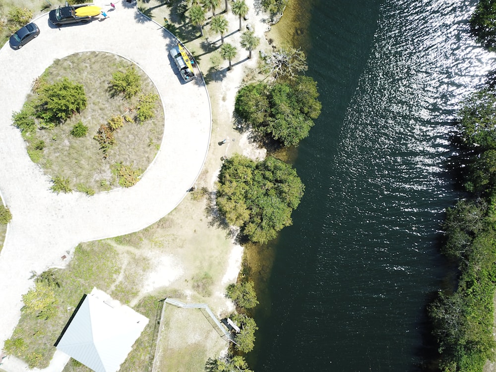 aerial view of green grass field near body of water during daytime