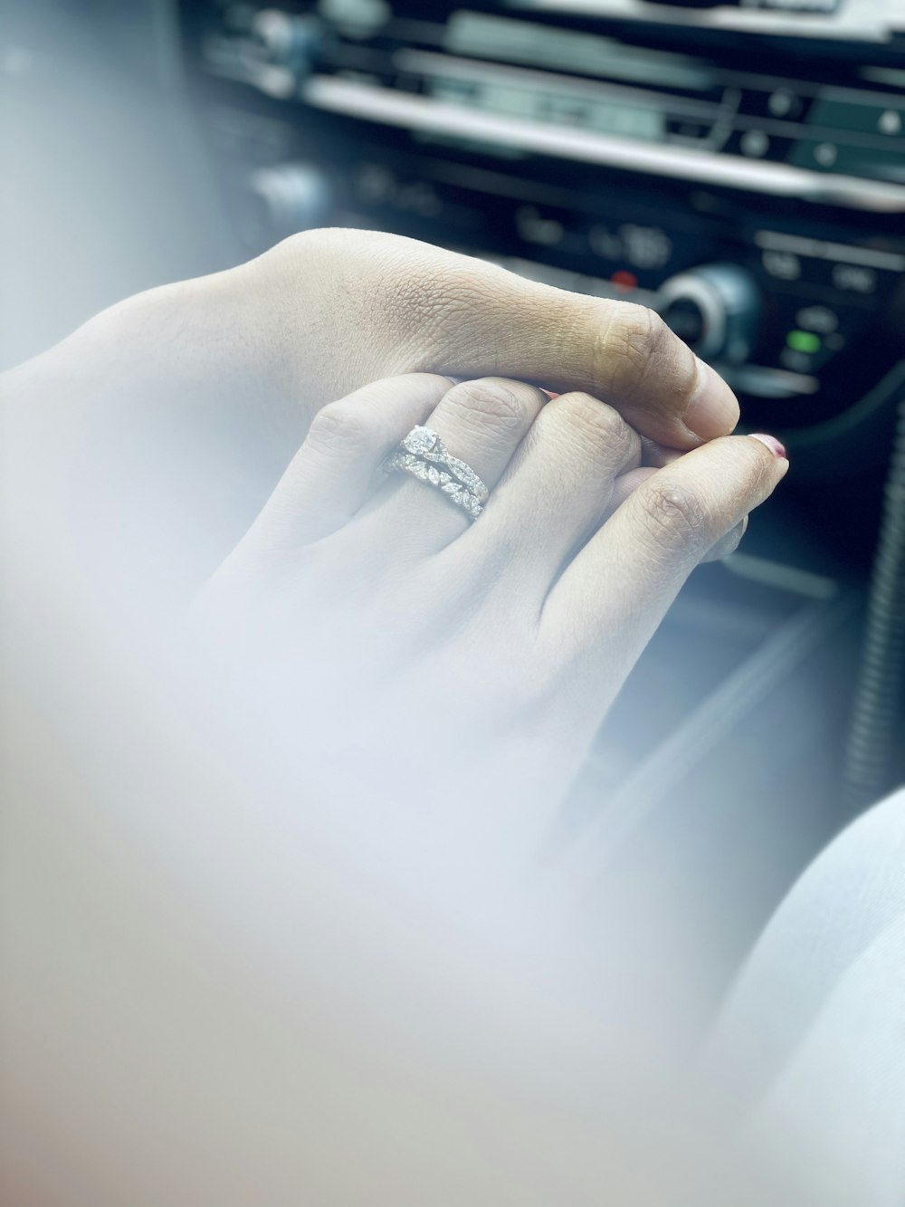 person wearing silver diamond ring