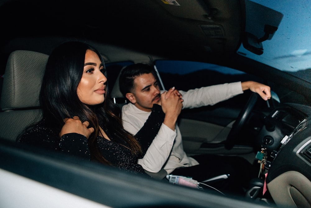 man and woman sitting inside car