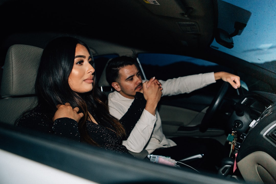 man and woman sitting inside car