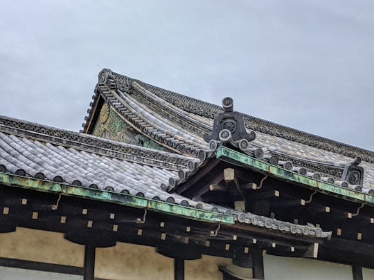 brown and black roof under white sky during daytime in Nijō Castle Japan