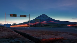 red and white bridge over the sea during night time