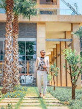 Stylish man wearing a crisp Colombian shirt, walking through a sunny Costa Rican street.