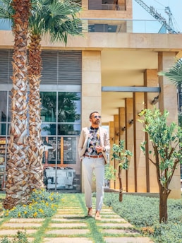 Stylish man wearing a crisp Colombian shirt, walking through a sunny Costa Rican street.