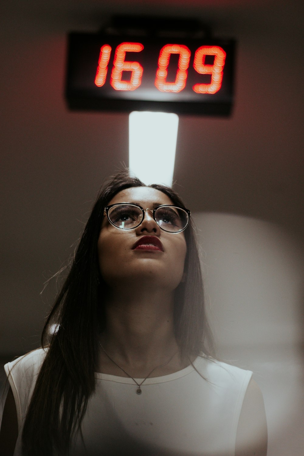 woman in white shirt wearing brown framed eyeglasses