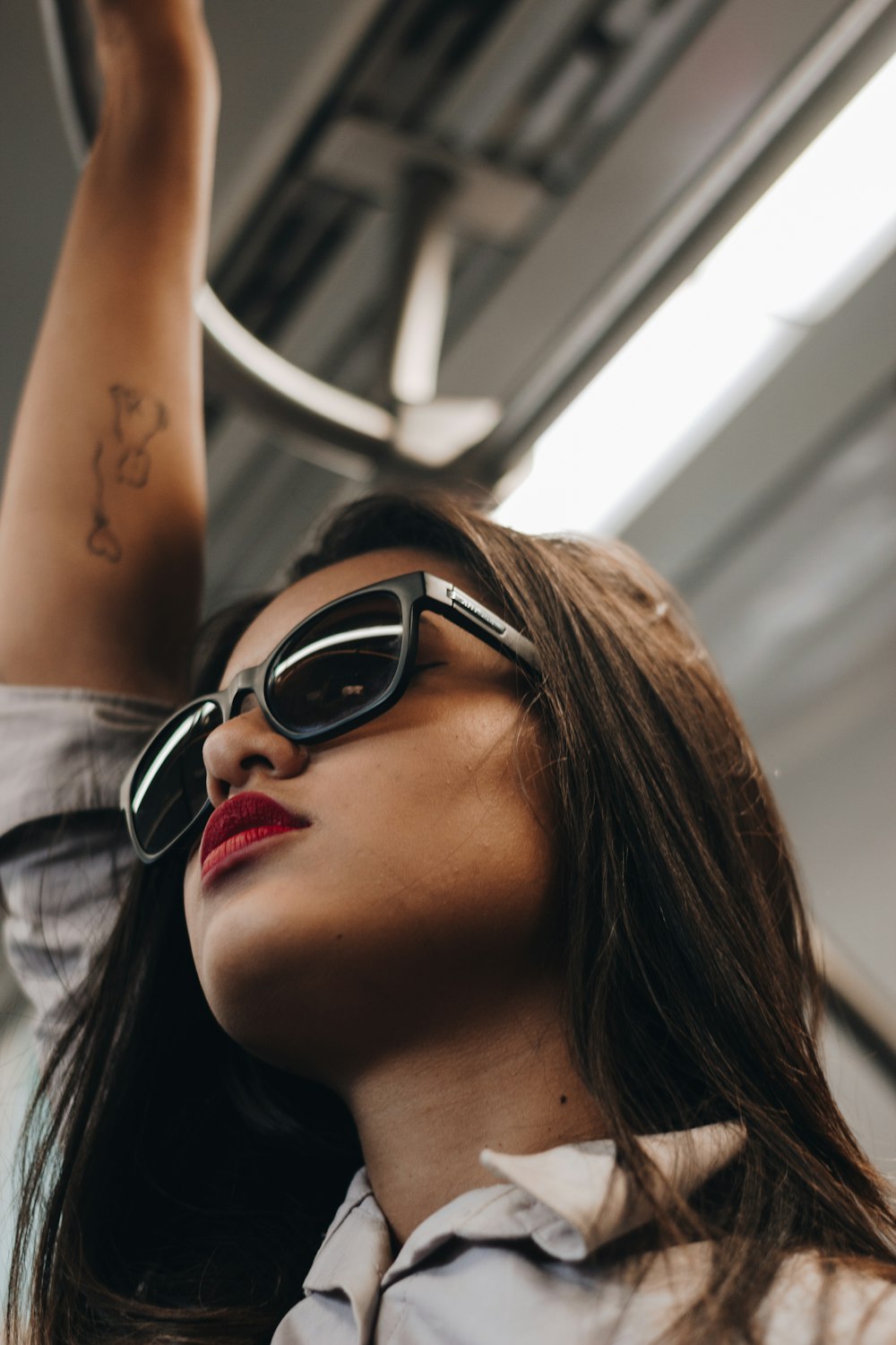 woman in black sunglasses and white shirt