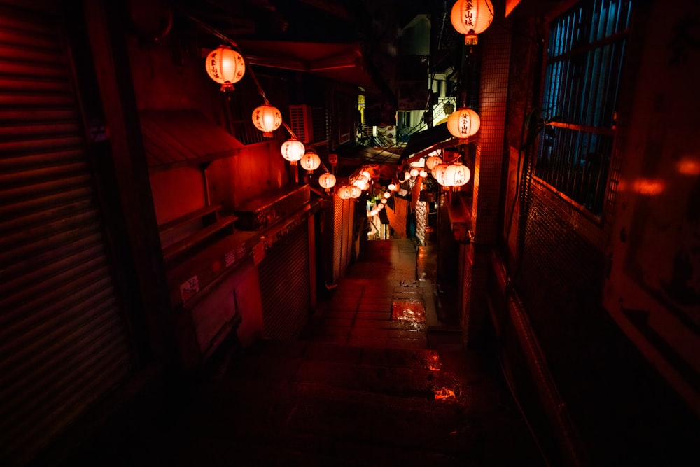 people walking on hallway with lighted pendant lamps