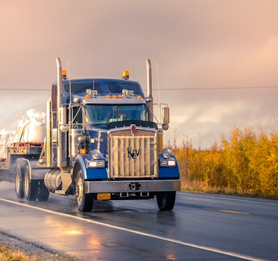 white and blue truck on road during daytime