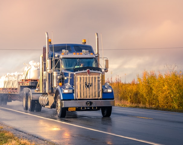 white and blue truck on road during daytime