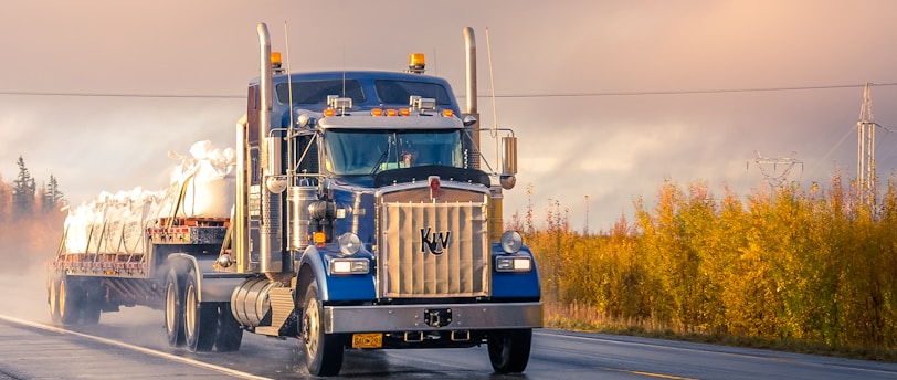 white and blue truck on road during daytime