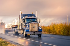 white and blue truck on road during daytime