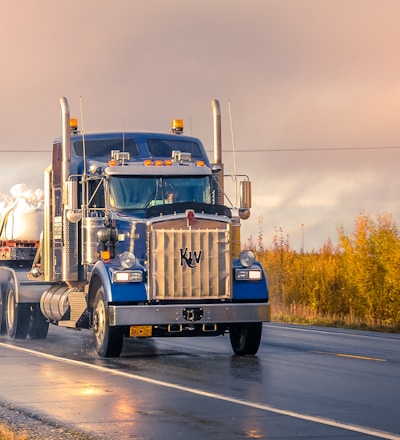 white and blue truck on road during daytime