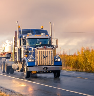 white and blue truck on road during daytime