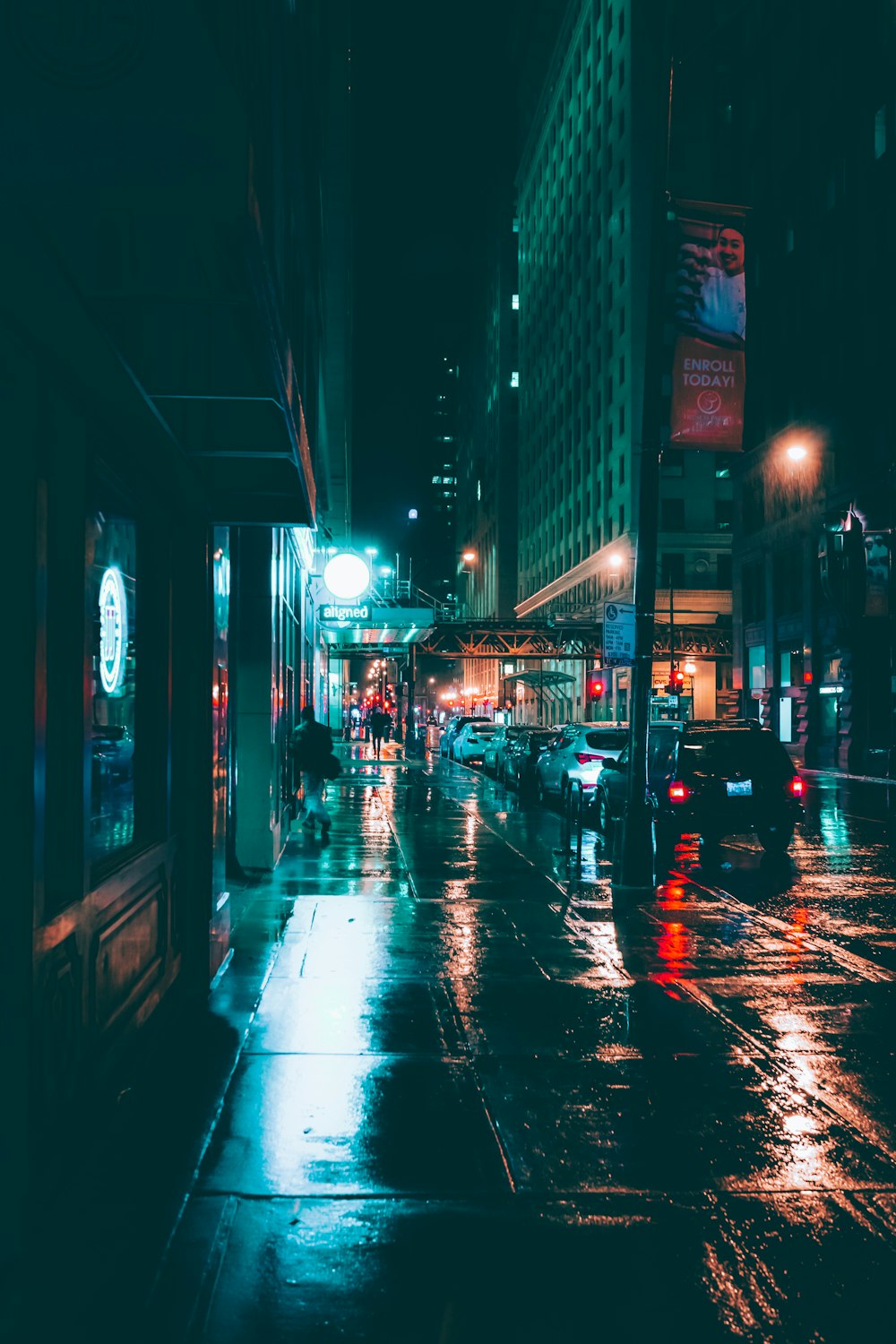 cars on road between buildings during night time