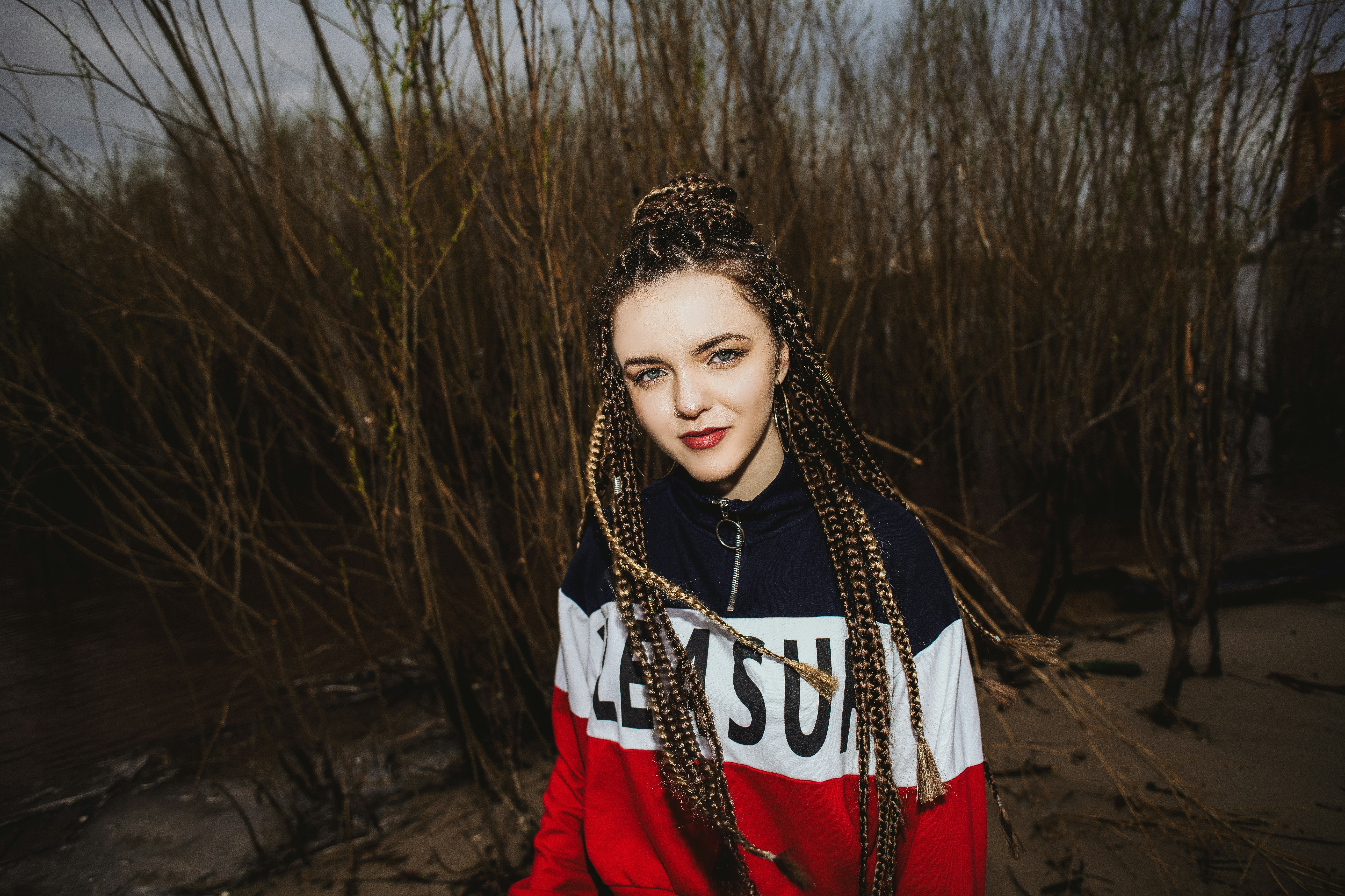 woman in red long sleeve shirt wearing black and white beaded necklace