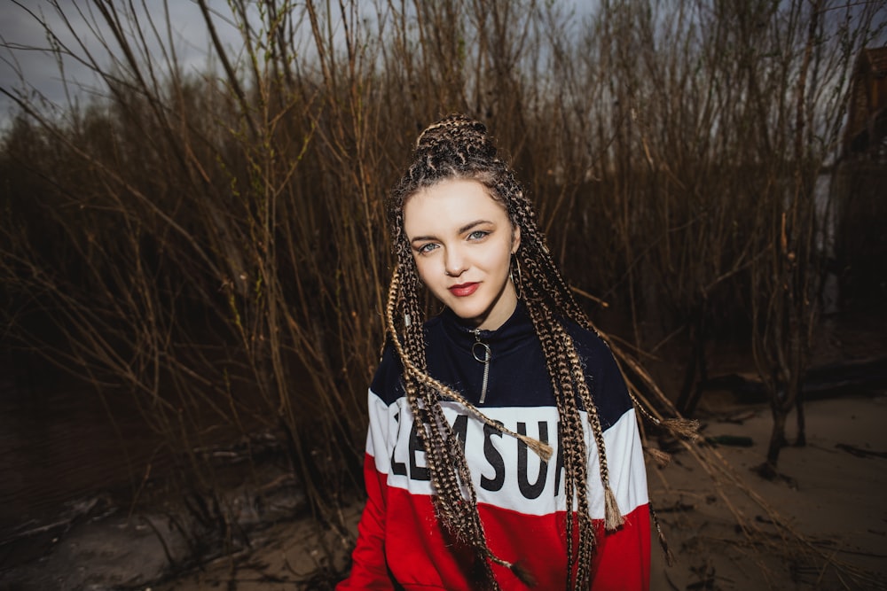 woman in red long sleeve shirt wearing black and white beaded necklace