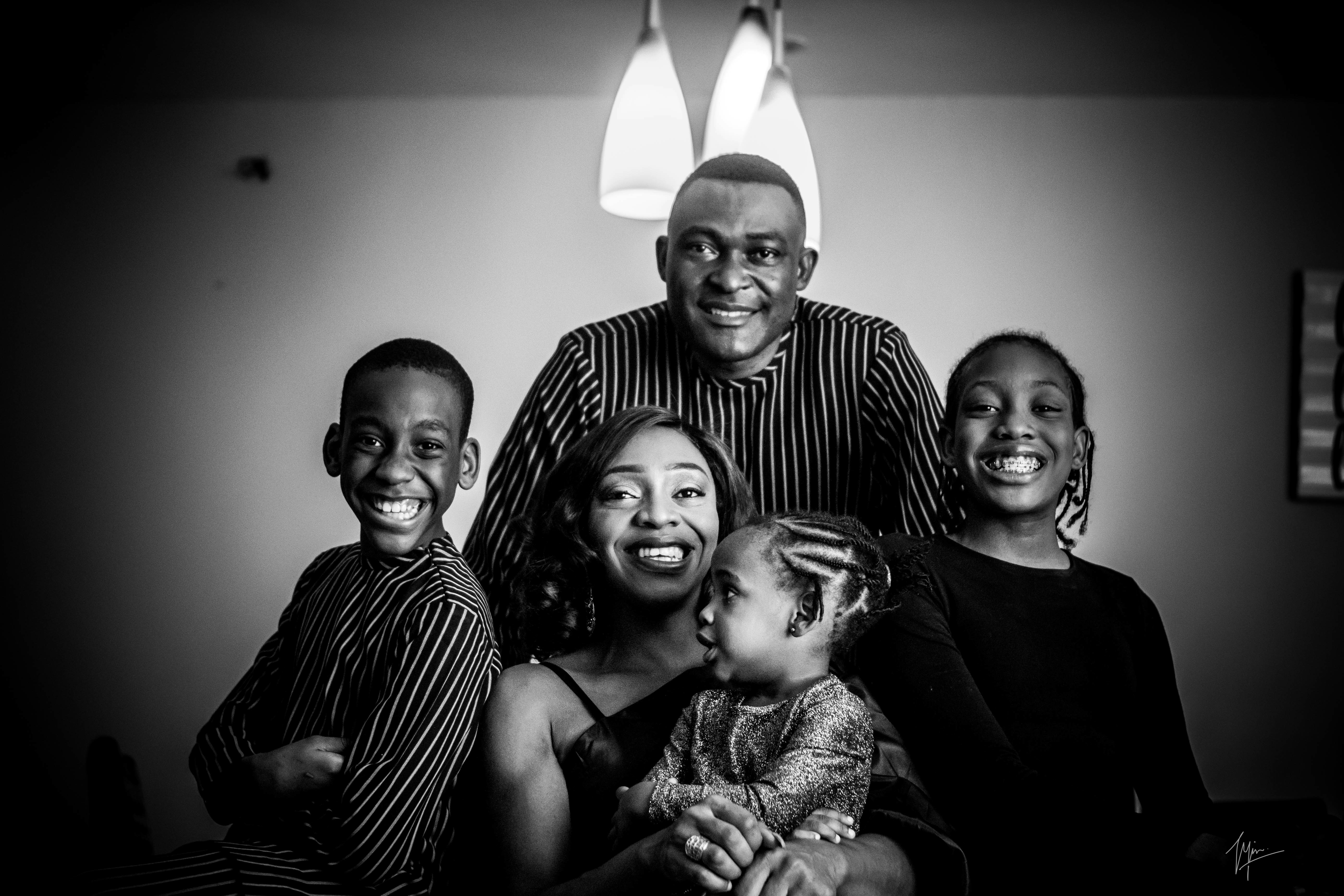 grayscale photo of 3 men and 2 women smiling
