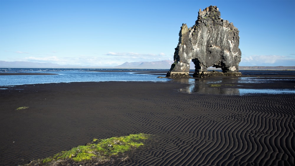 gray rock formation on sea shore during daytime