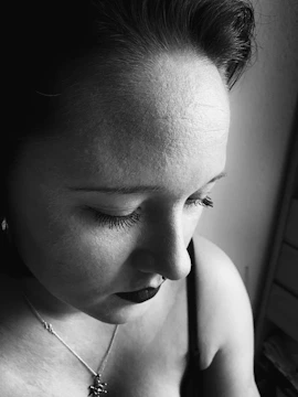 Black and gray realistic portrait tattoo capturing deep emotion.