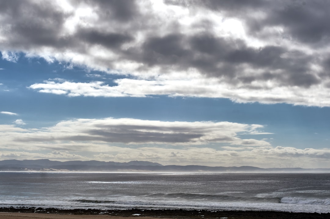 sea under blue and white cloudy sky during daytime