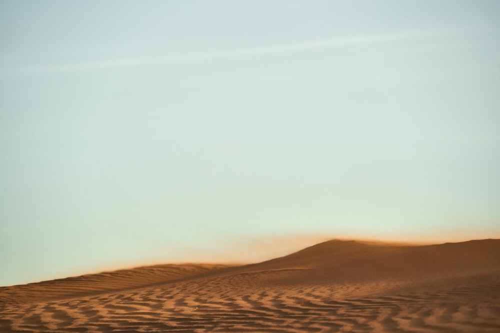 brown sand under white sky during daytime