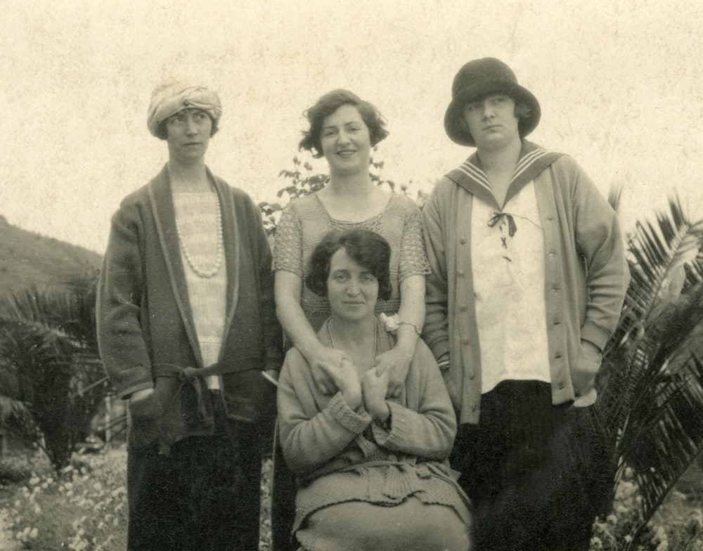 grayscale photo of 3 men and 2 women