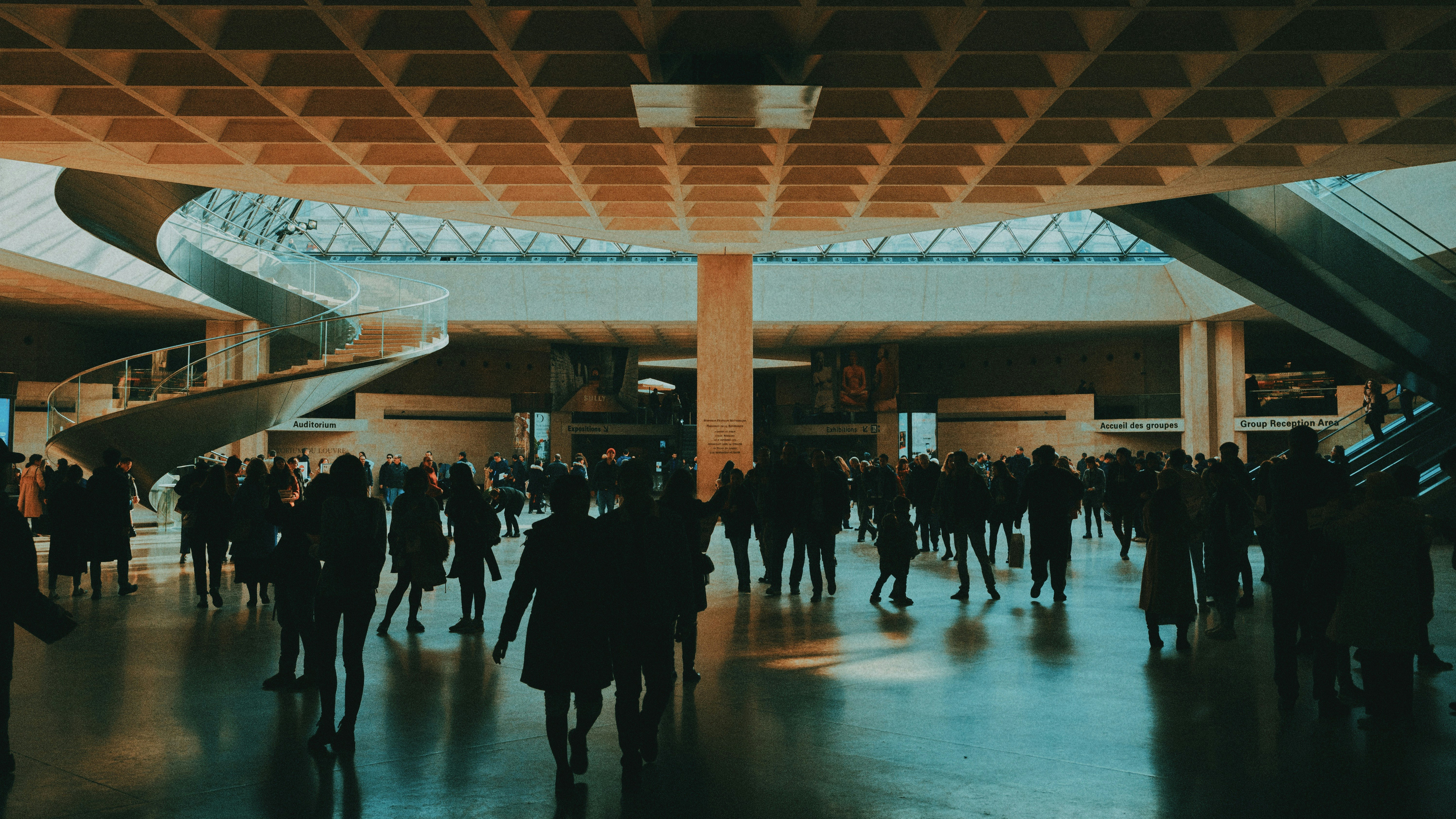 people walking on white floor tiles