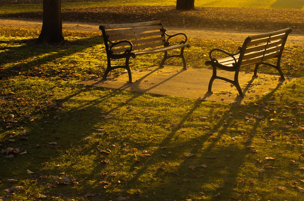 black metal bench on green grass field during daytime