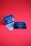 Two promotional cards against a bright red background. One card displays colorful guitar picks and has a modern design with text detailing the thickness and features. The other features a more subdued design with an image of a guitar and text about the product's new generation.