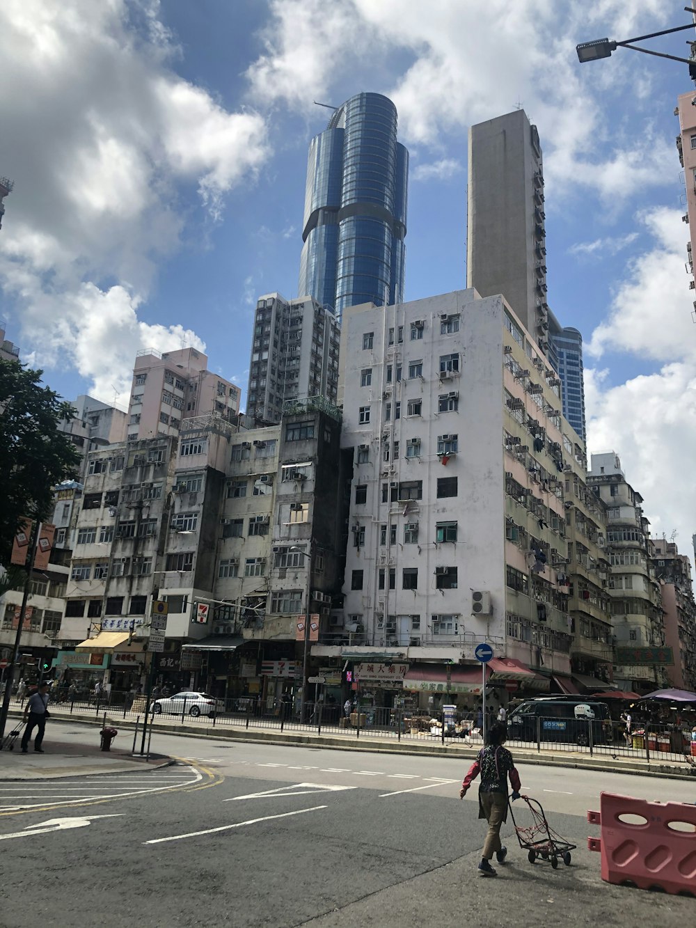 people walking on pedestrian lane near high rise buildings during daytime