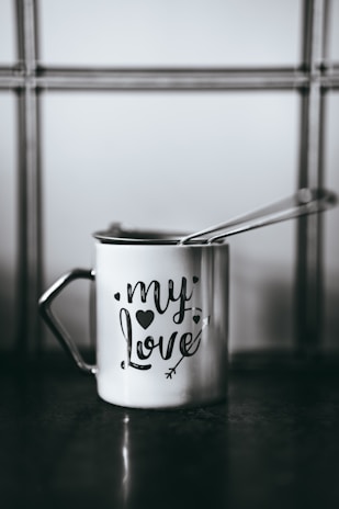 white and black ceramic mug with i love you print