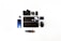 A flat lay of various electronic gadgets and accessories on a white background includes a camera, smartphone, wireless earbuds, computer mouse, portable hard drive, camera lens, and a tripod. A tablet with a dark cover is positioned centrally, accompanied by a lens cap.