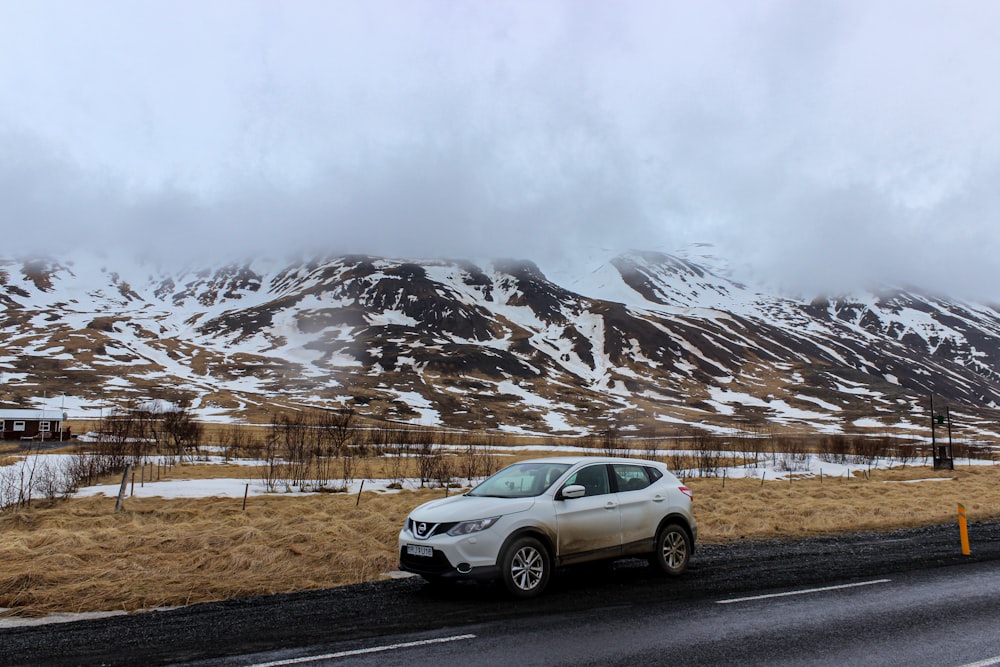 silver suv on road near snow covered mountain during daytime