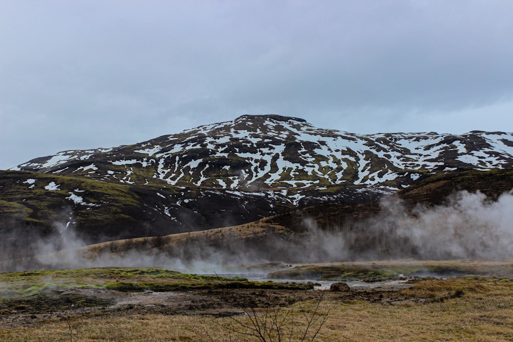 green and white mountain under white clouds during daytime