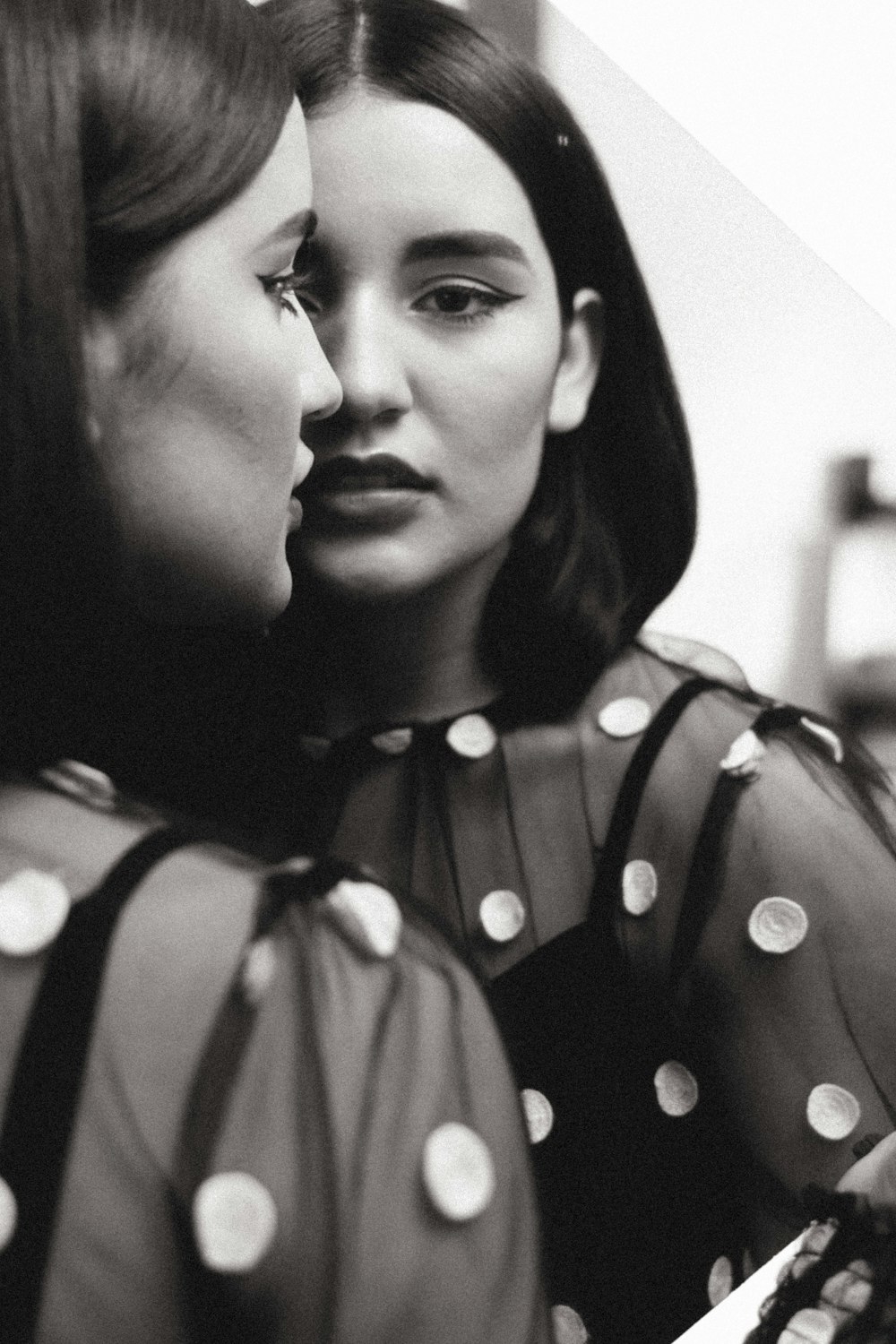 woman in black and white polka dot dress