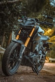 black and yellow motorcycle parked on the road