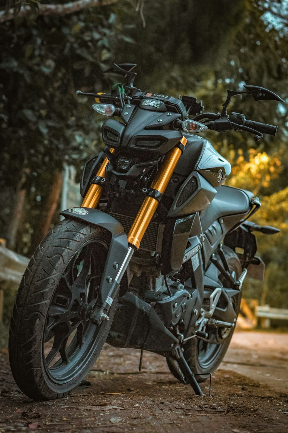 black and yellow motorcycle parked on the road