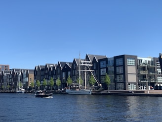white boat on water near building during daytime