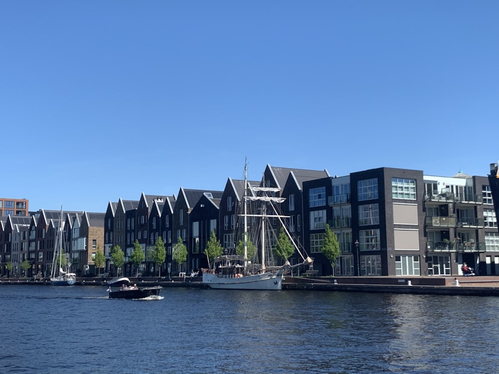 white boat on water near building during daytime