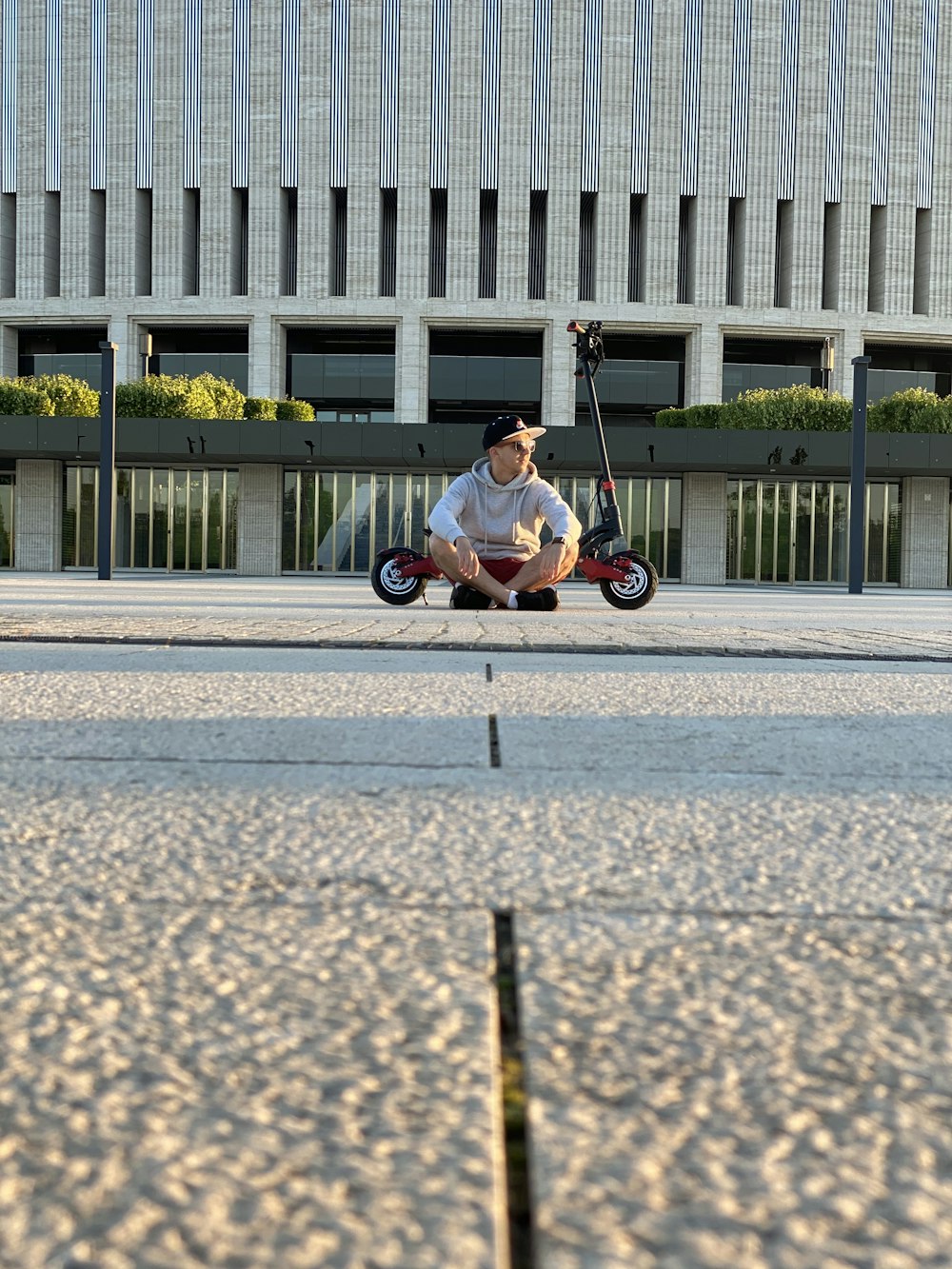 man in black shirt riding on black and white bicycle on gray concrete road during daytime