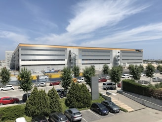 cars parked in front of white building during daytime
