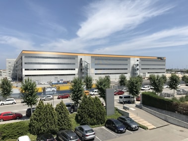 cars parked in front of white building during daytime