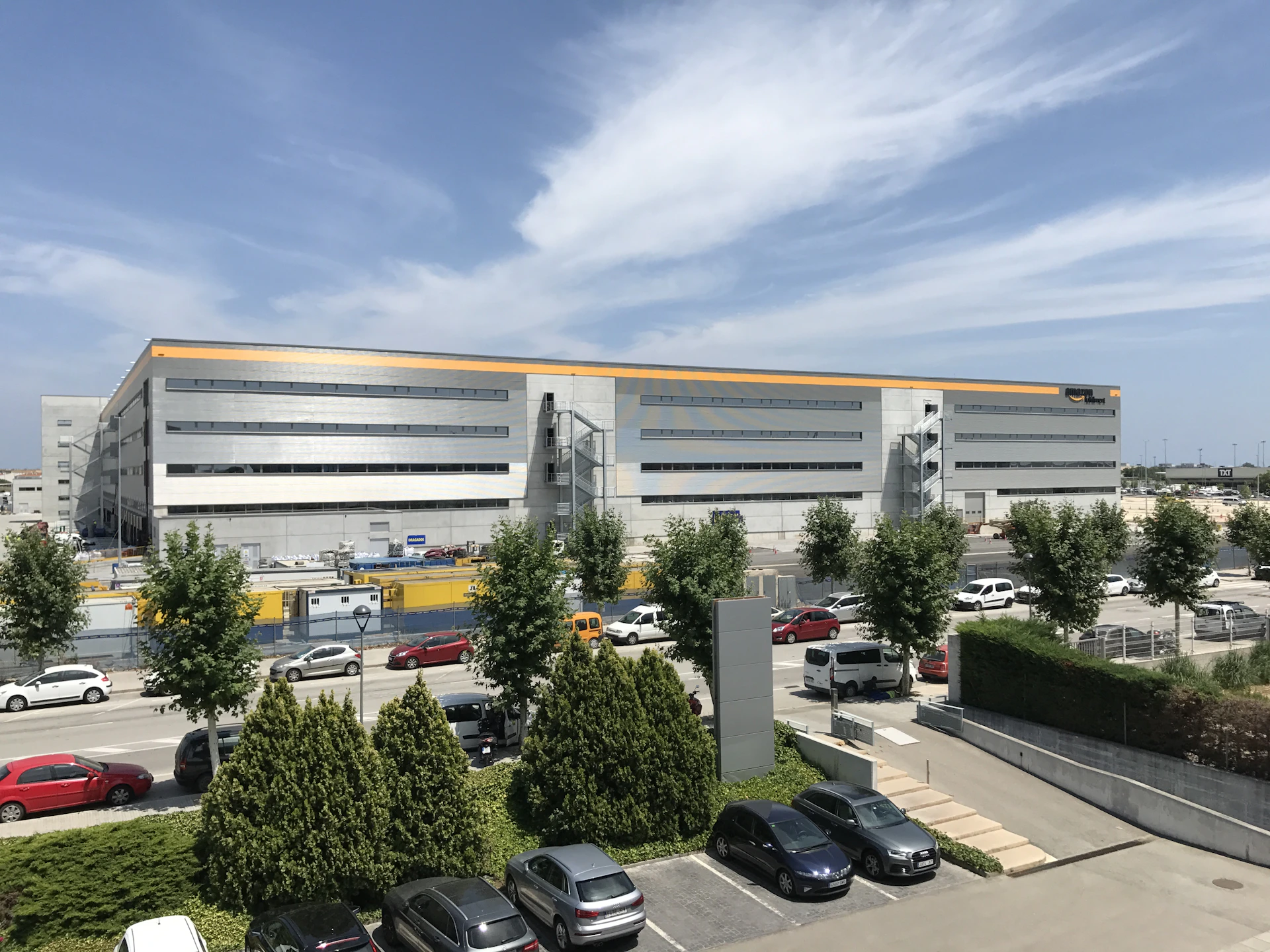 cars parked in front of white building during daytime