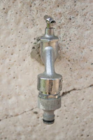 Hands holding a freshly replaced faucet fixture shining in natural light.