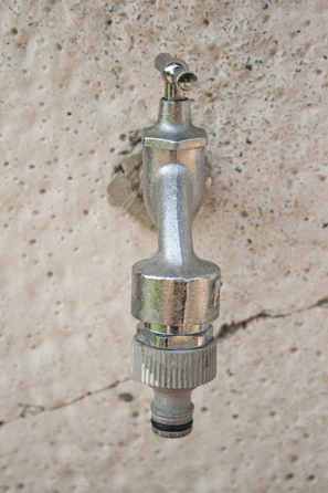 Hands holding a freshly replaced faucet fixture shining in natural light.