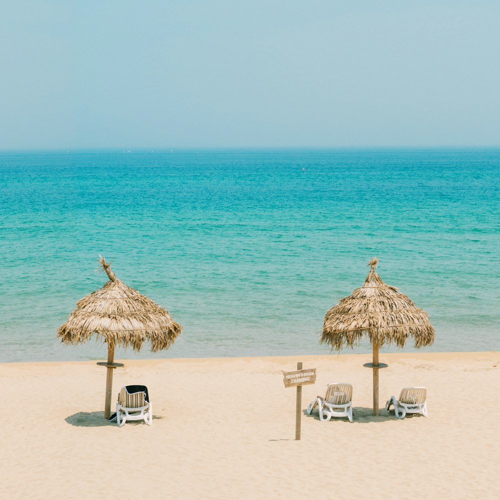 brown wooden beach lounge chairs on beach during daytime